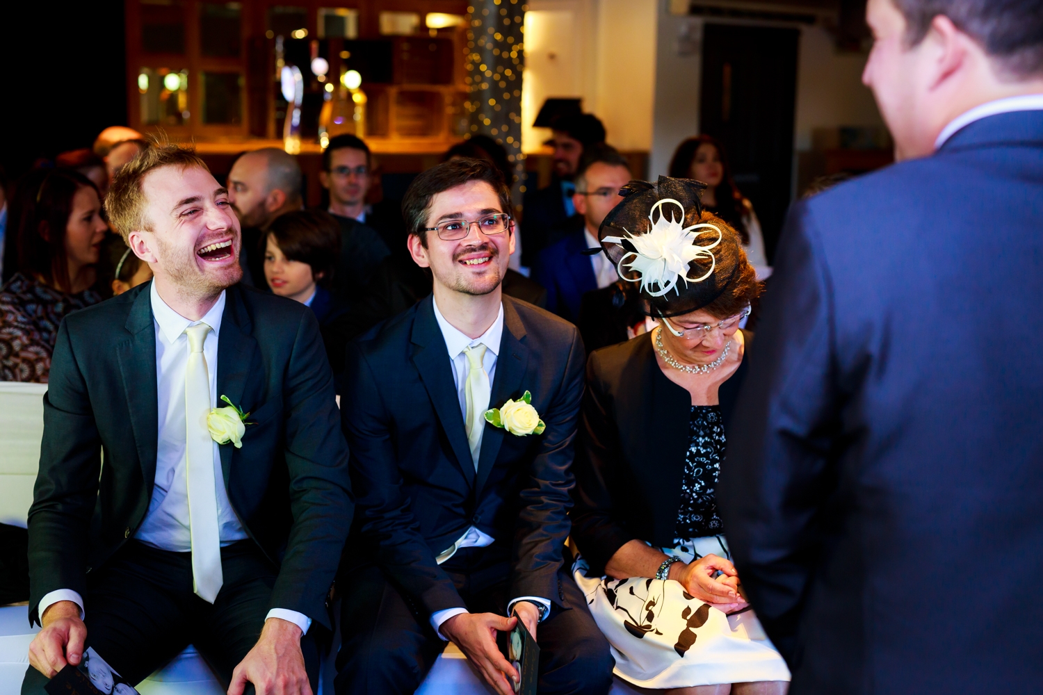 Saxon Mill Wedding Photographer - groomsman laughing and joking with the groom