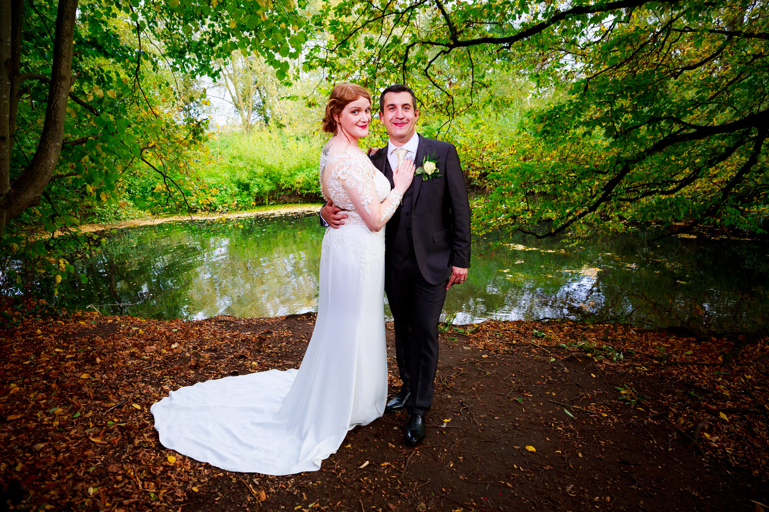 Saxon Mill Wedding Photographer - bride and groom hugging outside Saxon Mill lake