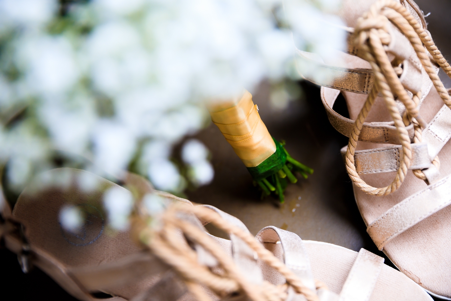 Danielle's bouquet and wedding shoes lying elegantly on a leather chair