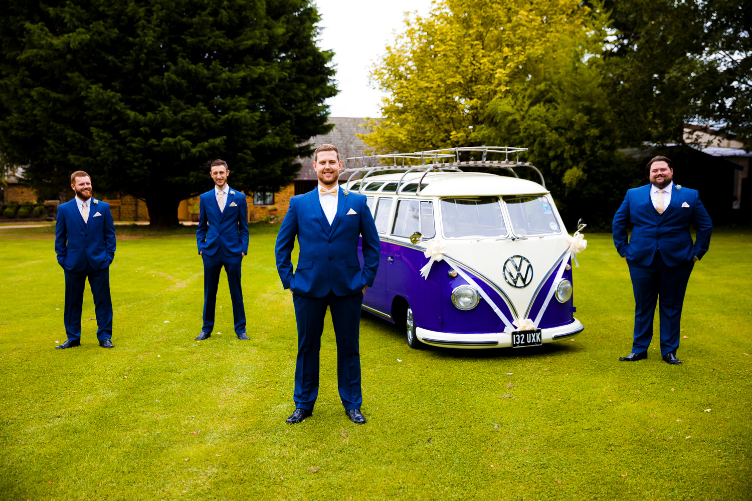 Elliot and the Groomsman posing outside the VW campervan wedding car