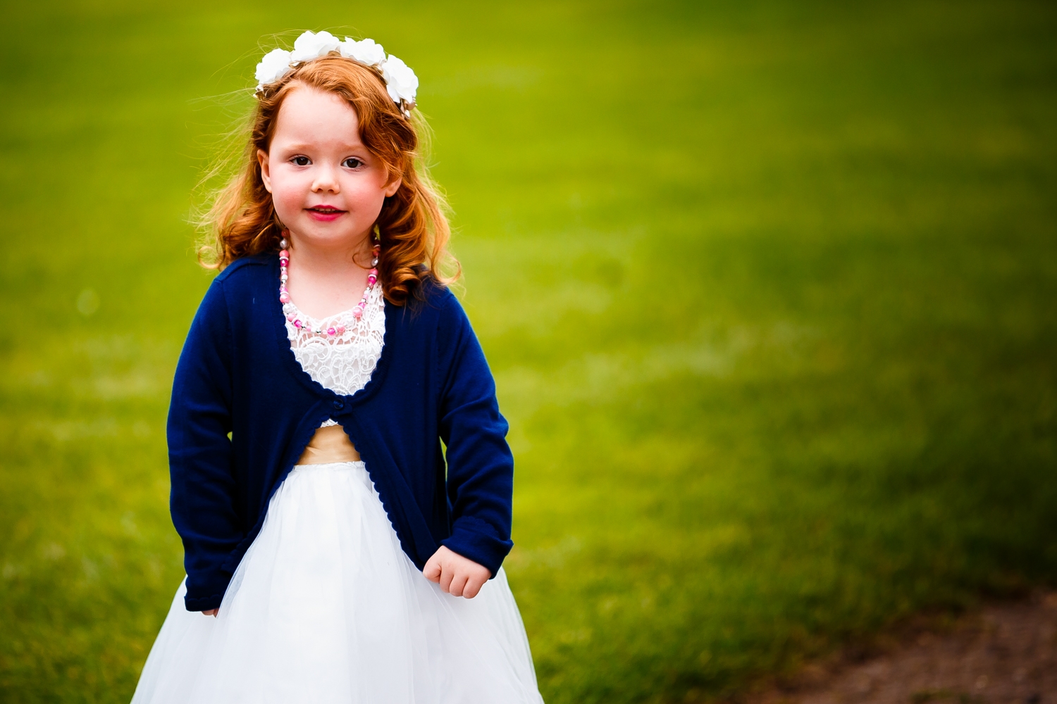 Flower girl posing in front of the camera