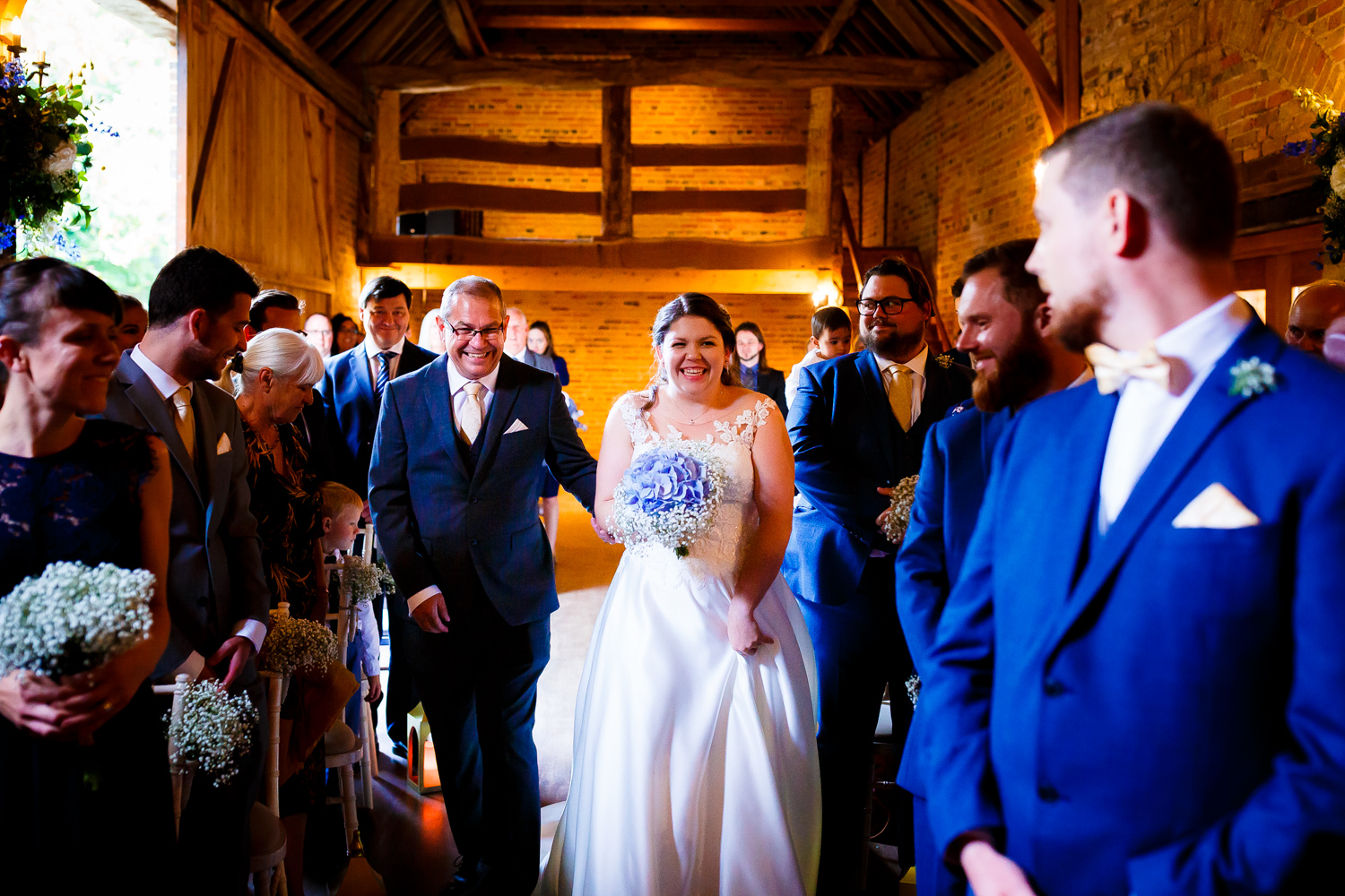 The beautiful brides walking down the aisle with her dad