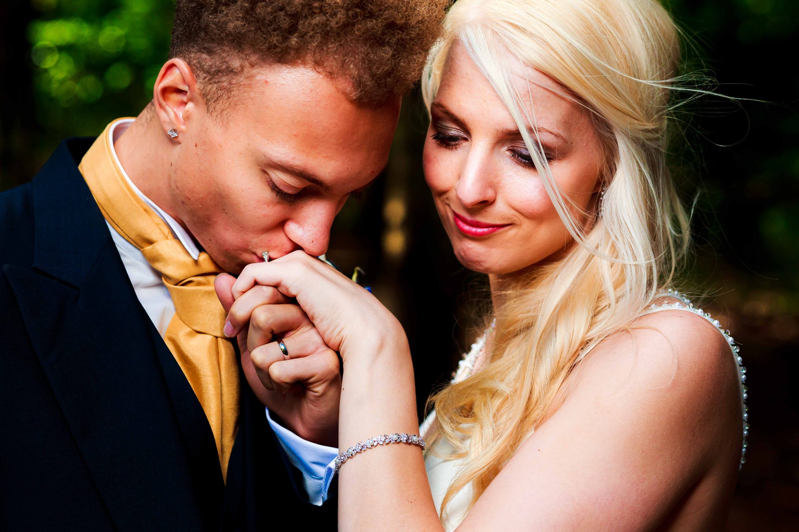 Groom kissing brides hand
