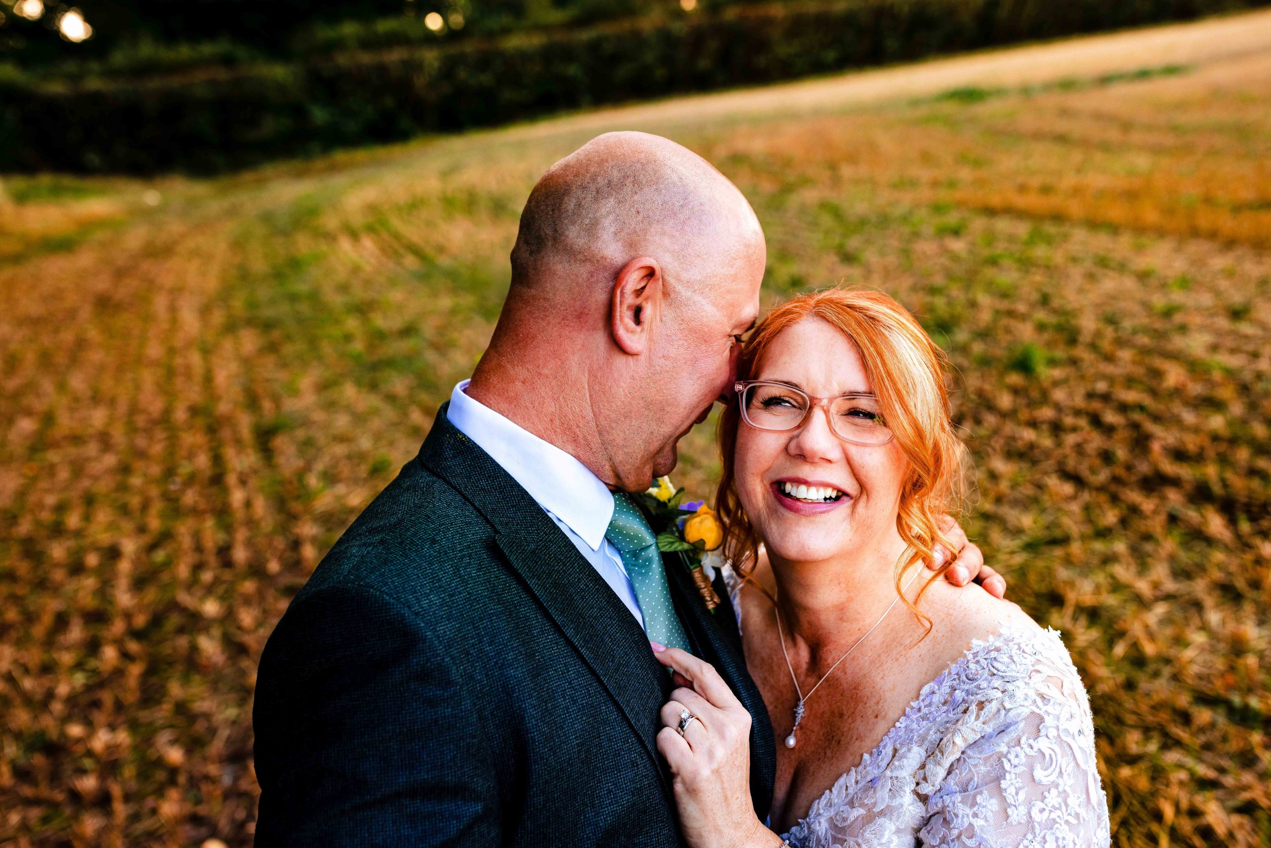 Artistic off camera flash photography of the bride and groom posing in front of a decorative mirror